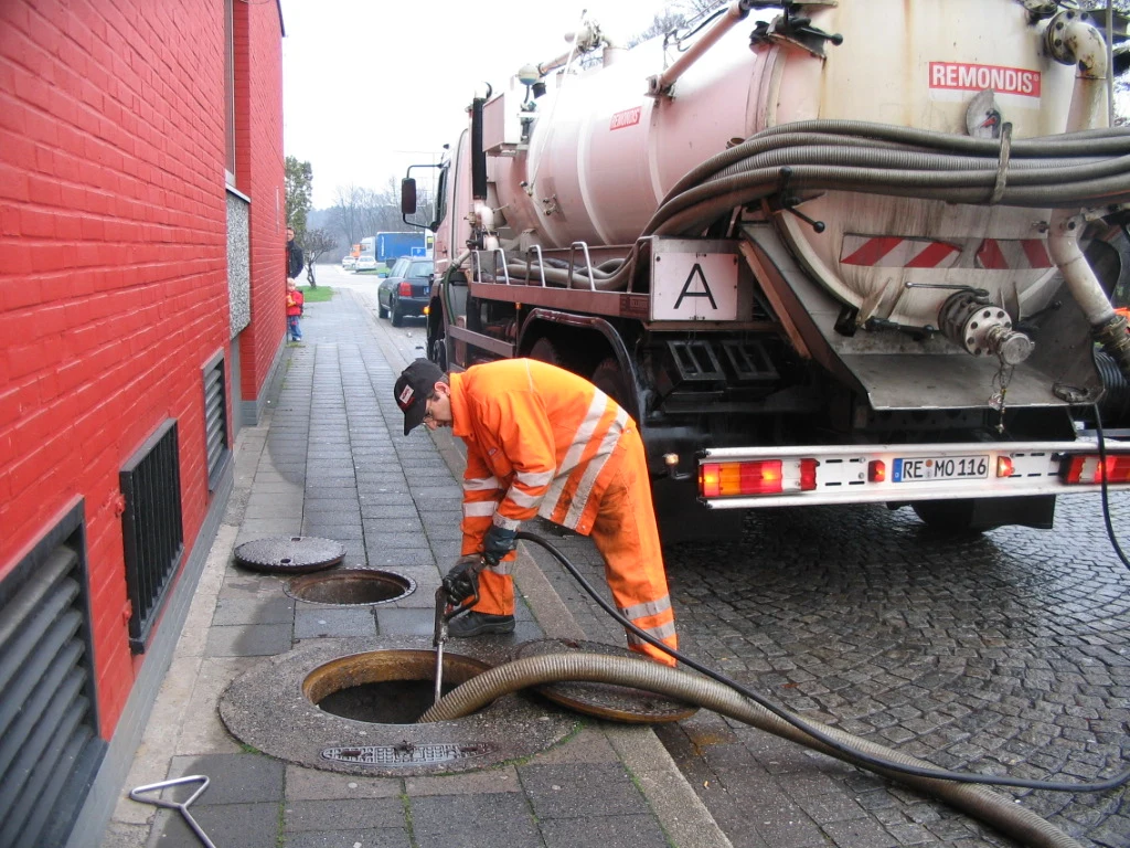 Vacuum truck pumping a sewage tank
